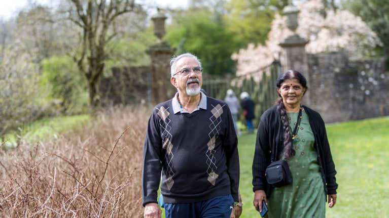Visitors walk through the garden in spring at Sizergh Castle, Cumbria
